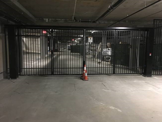 black four fold gate in a parking garage