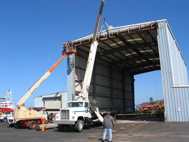 one of the types of commercial doors. This image shows a coiling door for a large hanger used to store and refurbish boats. This is from a Door Company project on the coast of California