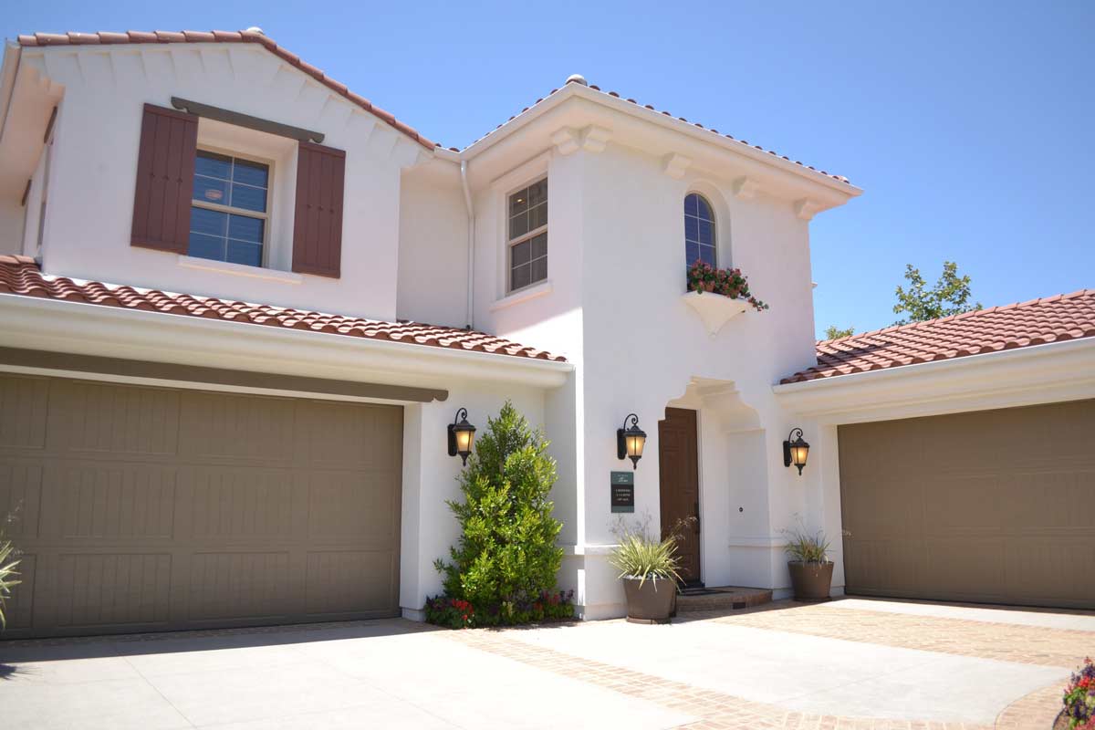 House that has a brown garage door with a standard bottom garage door seal type. 