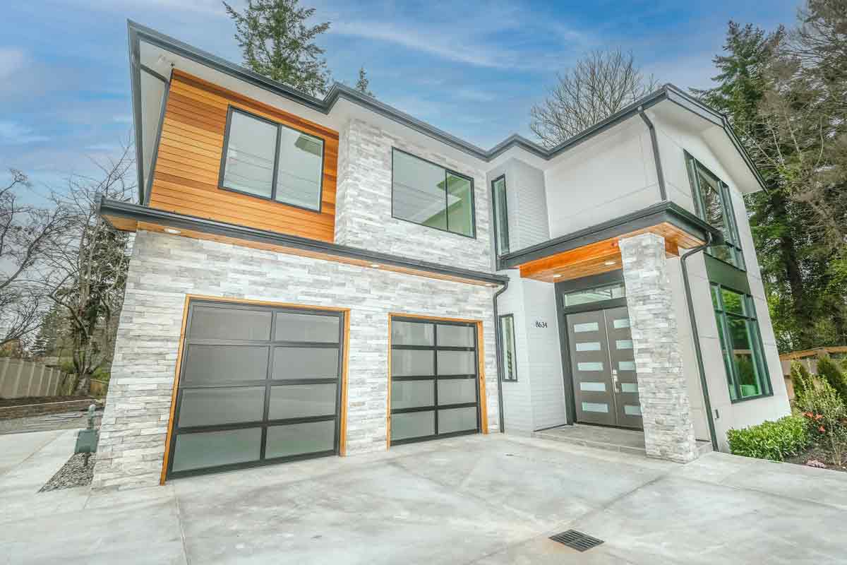 Modern house with a glass garage door that has both a side and bottom garage door seal.