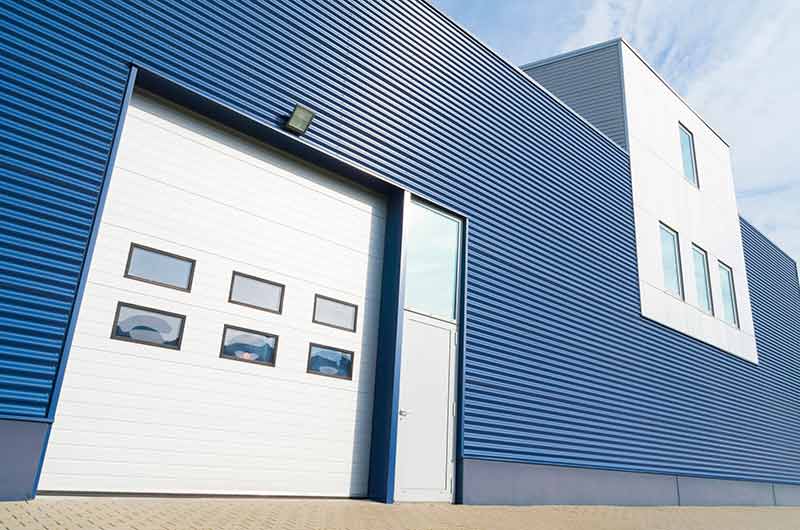 Picture of exterior warehouse showcasing The Door Company's garage door services