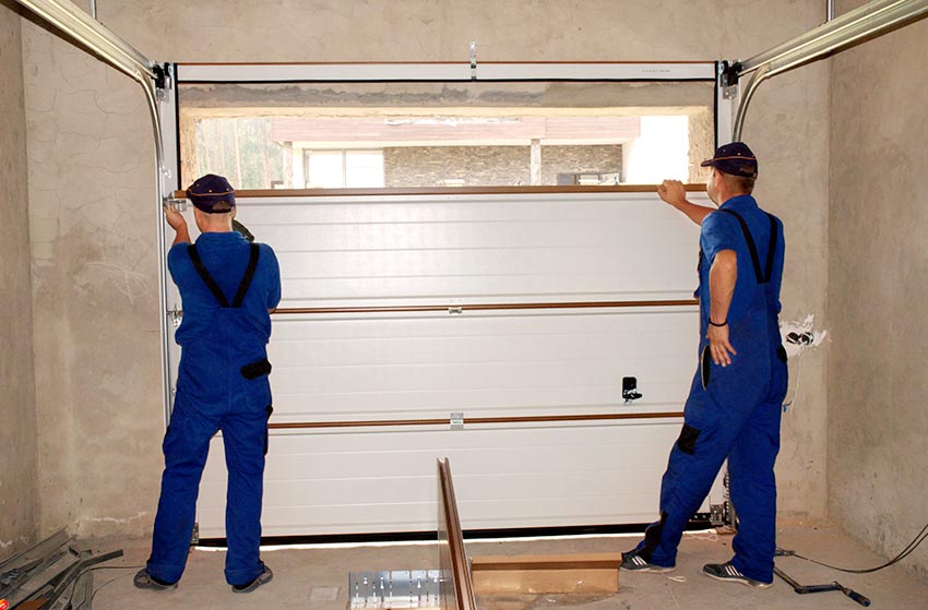 Technicians fixing a garage door