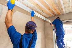 Garage door technicians installing a garage door